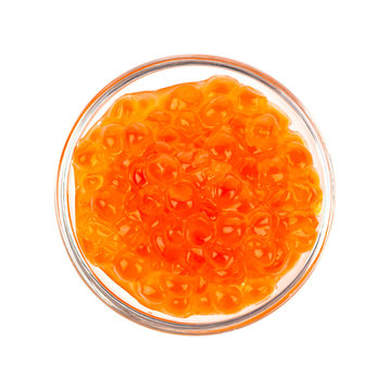 Red caviar in the glass bowl isolated on a white background.