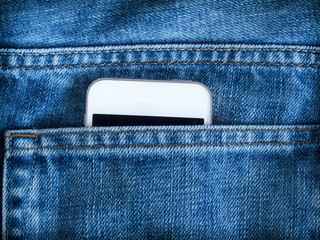 Mobile phone in pocket of blue jeans.