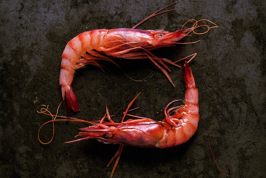 Two prawns on a black stone