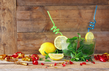 fresh mojito, party confetti and sliced lemons at the bar