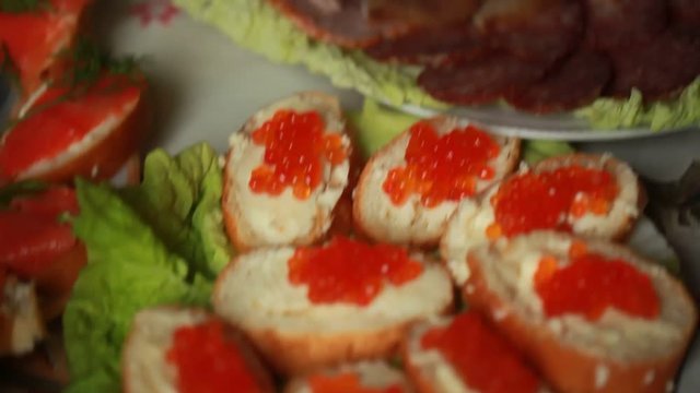 sandwiches with red caviar on a table in a cafe