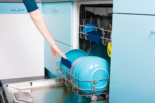 Woman Empty Out The Dishwasher