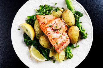 Pan fried Salmon Served with potatoes and tenderstem broccoli.