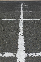 painted signs on an old parking lot