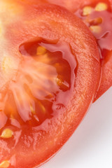 Macro closeup sliced tomato over white background copy space