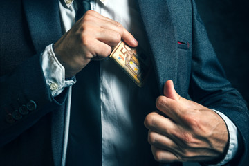 Money in pocket, businessman putting euro banknotes in suit pock - obrazy, fototapety, plakaty