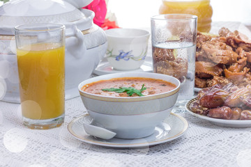 Bowl of Moroccan harira soup,chebakia, dates for iftar