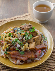 china noodle mixed with egg, sausage, pork, mushroom and tofu