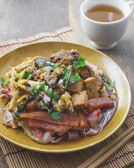 china noodle mixed with egg, sausage, pork, mushroom and tofu