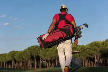 golfer walking and carrying golf bag