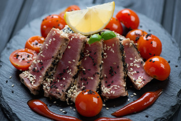 Slices of tuna fillet roasted in sesame seeds, close-up