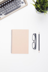 notebook and typewritter place on white background