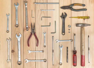 Set of old hand tools on wooden table. Top view. Many tools have a rust and dirty from working.