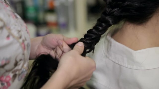 Barber making beautiful hairdo with braid