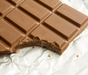 delicious bitten chocolate bar on foil packaging