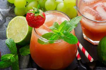 Fresh strawberry drink, cold juicy lemonade with limes and mint