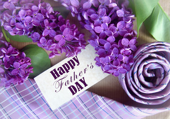 Beautiful purple lilac and tie for father's day. Greeting card. Abstract concept background for father's day celebration