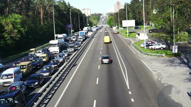 Long line of cars on highway, traffic jam because of accident, impatient drivers
