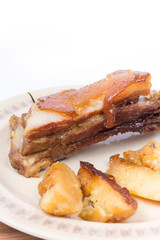 Pork ribs with potatoes on the plate