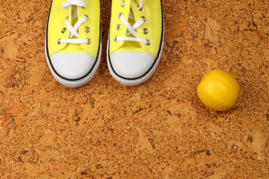Yellow Sneakers On A Background Of Cork