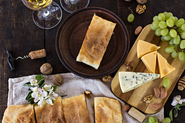 Сheese pie, strudel with cheese, cheese pie 4. Wine, grapes, nuts, cheese, blue cheese, and coffee. dinner, lunch, romantic date, picnic, eating on nature.