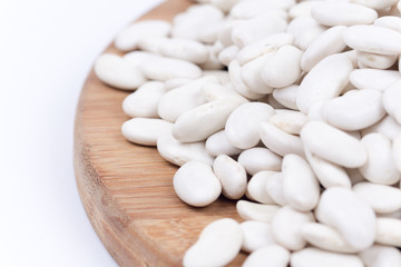 White beans on the wooden board. Isolated copy space