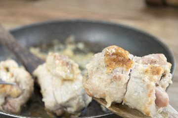 turkey roll on a wooden spoon in a pan