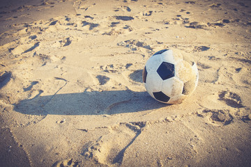 Soccer ball on sand (Vintage filter effect used)