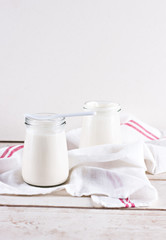 organic dairy products (yogurt, sour cream) in a glass jar