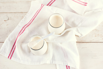 organic dairy products (yogurt, sour cream) in a glass jar