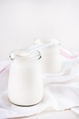 organic dairy products (yogurt, sour cream) in a glass jar