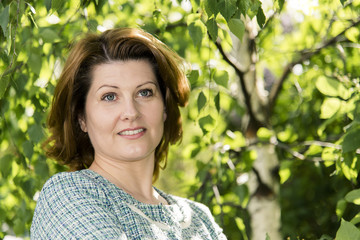 Portrait of Russian woman in abirch grove