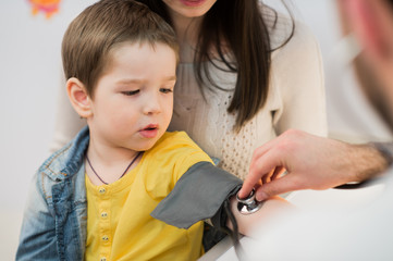 Little boy medical visit - doctor measuring blood pressure of a child - 111323722