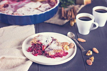 Cherry pie and a cup of coffee. Rustic style. Berry pie. Homemade cherry pie with flaky crust, cup of coffee, bowl with cherries