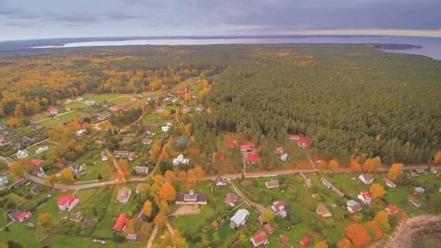 The view on an aerial shot of Kasmu village where seen the big ocean fronting the small village with lots of trees and houses