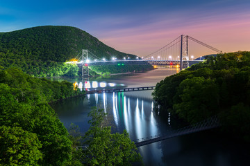 Hudson River valley with Bear Mountain bridge illuminated by night, in New York state - obrazy, fototapety, plakaty