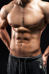 Fototapeta na wymiar Close-up of a power fitness man on black background