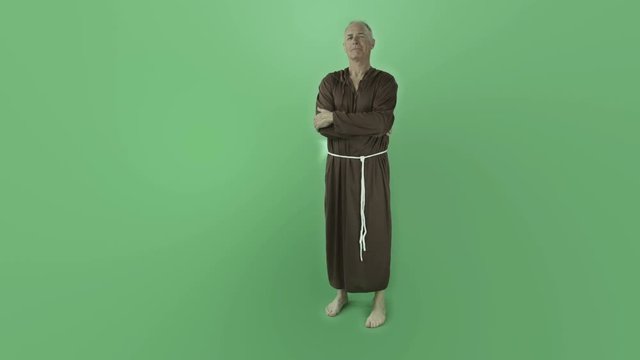 Senior caucasian monk isolated on chroma green screen confident