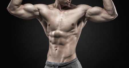 Fototapeta na wymiar Fitness man model torso posing and showing perfect body