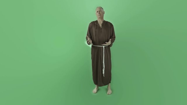 Senior caucasian monk isolated on chroma green screen anger upset