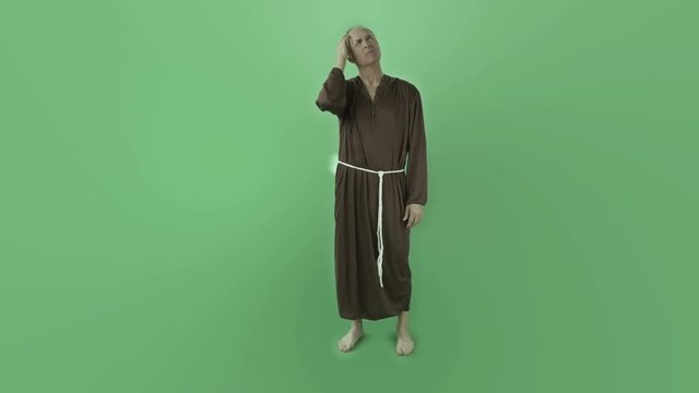 Senior caucasian monk isolated on chroma green screen thinking scratching head