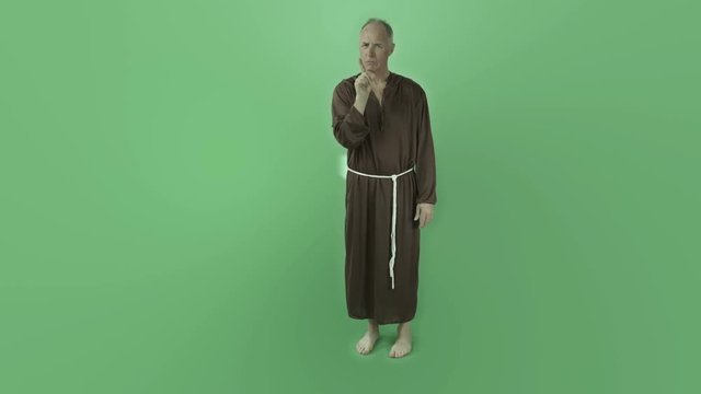Senior caucasian monk isolated on chroma green screen silence secret