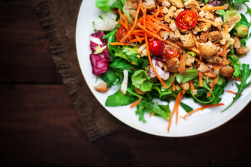 Healthy Salad with arugula, tomatoes and Croutons. Vegetable sal