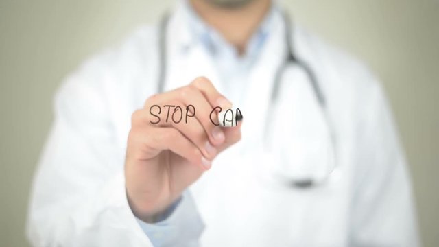 Stop Cancer, Doctor writing on transparent screen