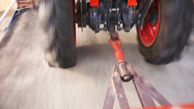 tractor car tow running fast through street action POV scene 