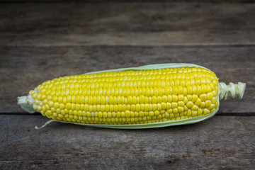 fresh corn on wooden table