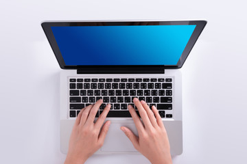 Fototapeta na wymiar woman hand using laptop in top view