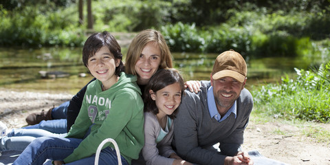 Familia feliz tumbada en el campo