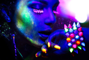 Fashion woman in neon light, portrait of beauty model with fluorescent makeup