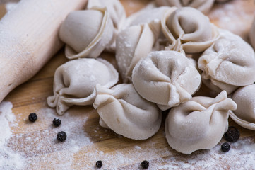 raw dumpling on bamboo wickerwork with flour and pepper